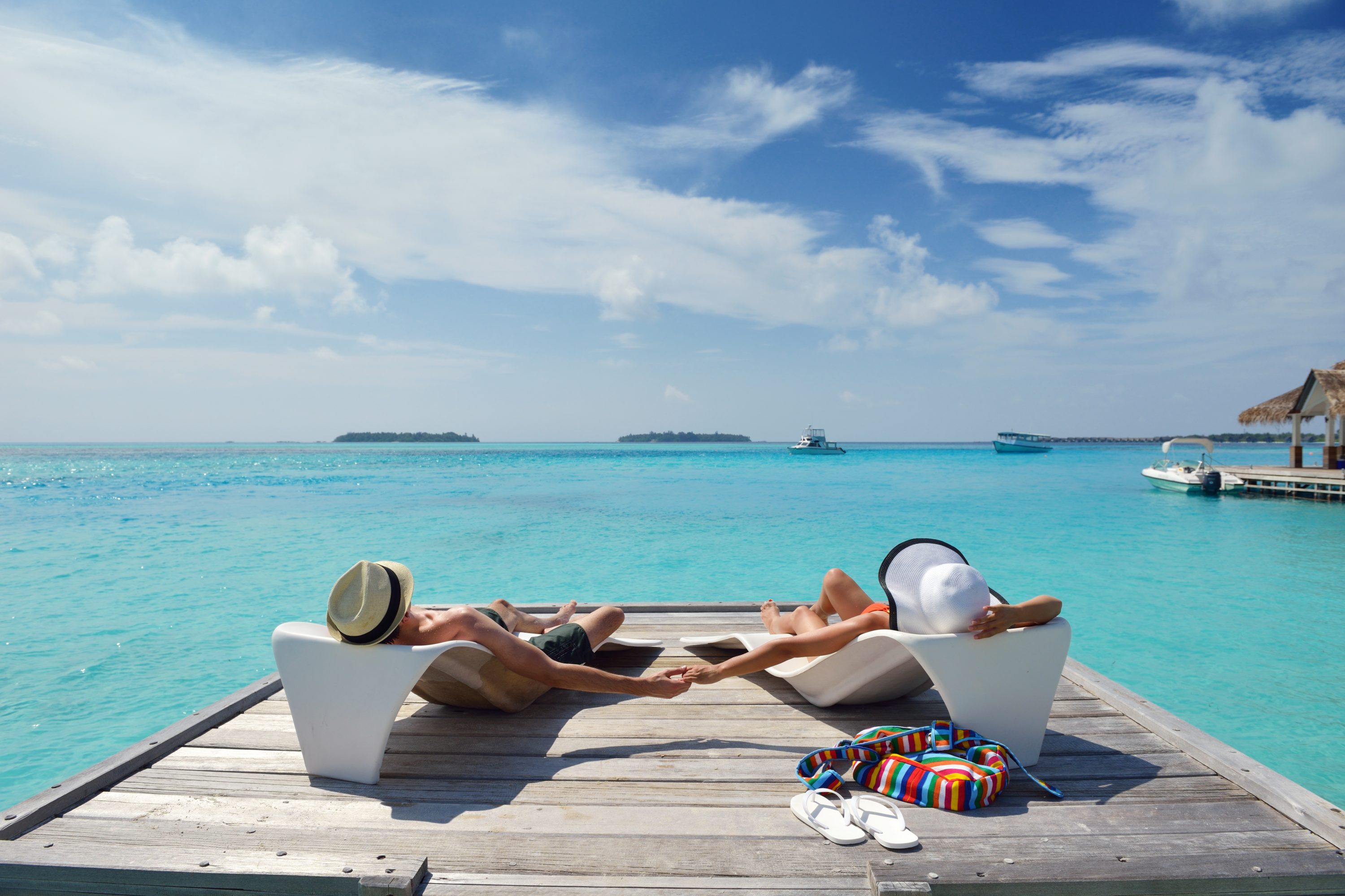 Отпуск. Отпуск у моря. Мальдивы любовь. Пара на шезлонге у моря. Человек на лежаке на пляже.