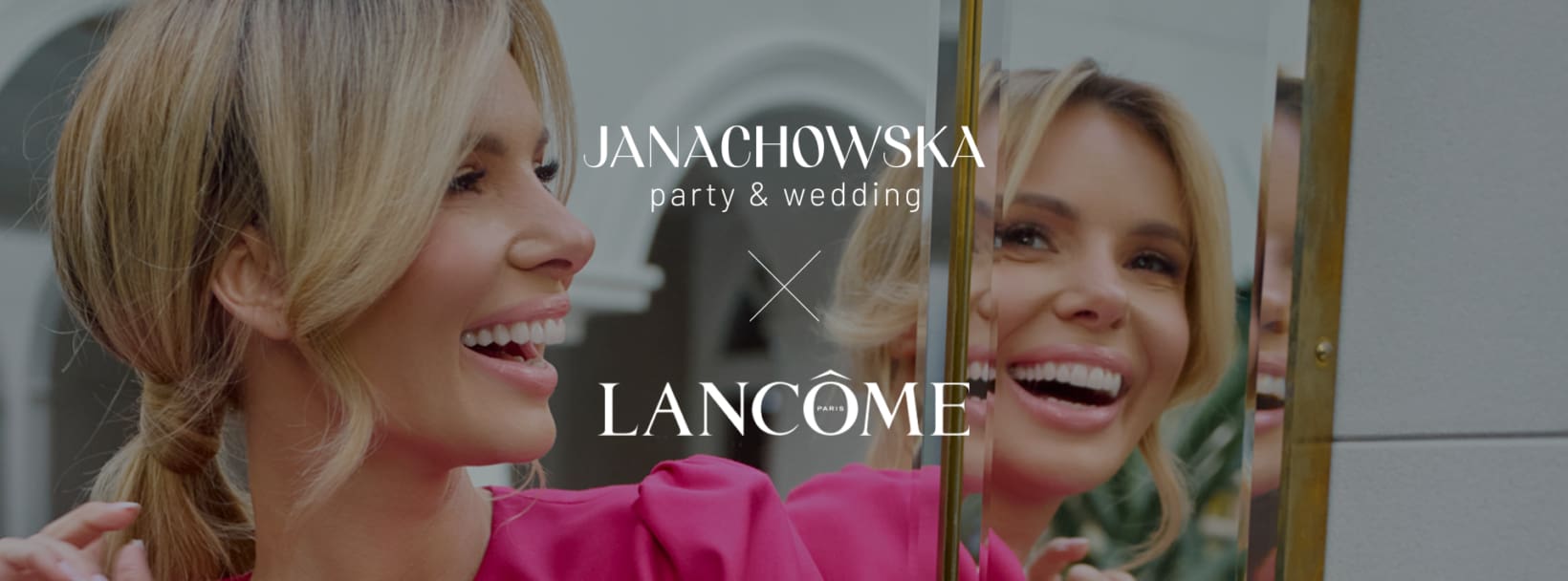 Uśmiechnięta kobieta w różowej sukience przed lustrem, logo Janachowska party & wedding oraz Lancôme